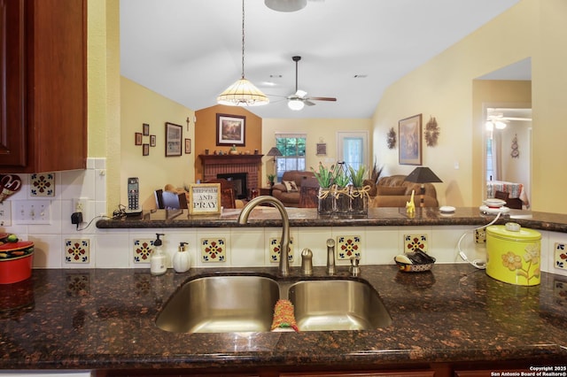 9519 Braun Shr, San Antonio, TX 78250 - kitchen featuring ceiling fan, a sink, open floor plan, vaulted ceiling, and tasteful backsplash