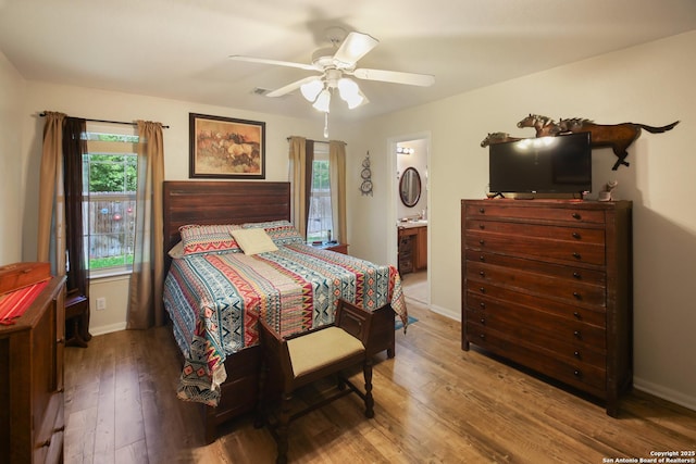 9519 Braun Shr, San Antonio, TX 78250 - bedroom with wood finished floors, baseboards, ceiling fan, and ensuite bathroom