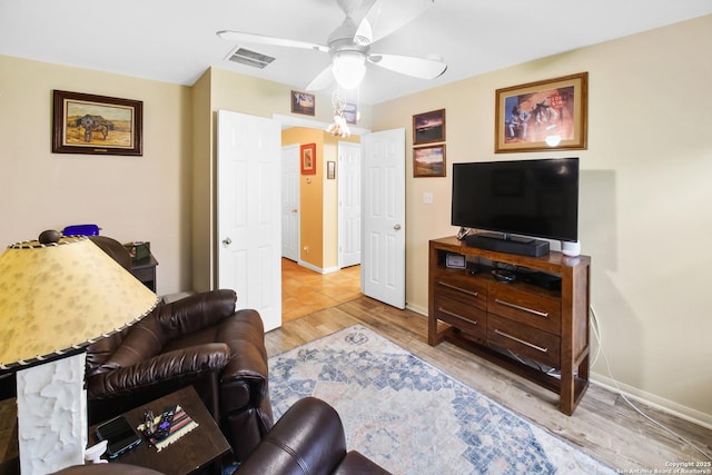9519 Braun Shr, San Antonio, TX 78250 - living room featuring ceiling fan, light wood finished floors, and baseboards