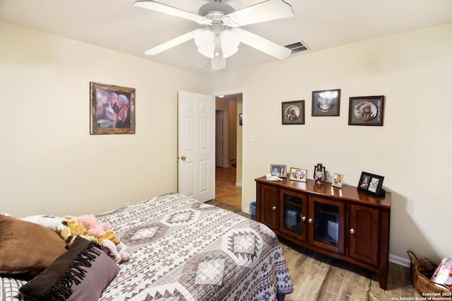 9519 Braun Shr, San Antonio, TX 78250 - bedroom with light wood finished floors, a ceiling fan, and baseboards