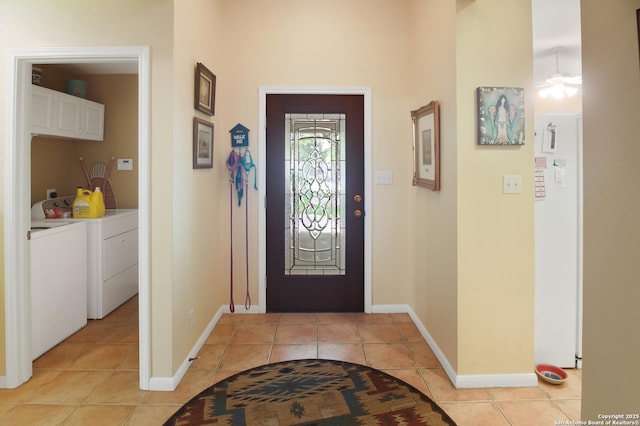 9519 Braun Shr, San Antonio, TX 78250 - entrance foyer featuring separate washer and dryer, light tile patterned floors, baseboards, and a ceiling fan