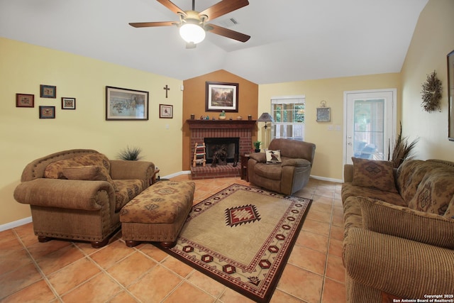 9519 Braun Shr, San Antonio, TX 78250 - living area featuring ceiling fan, vaulted ceiling, light tile patterned flooring, a brick fireplace, and baseboards