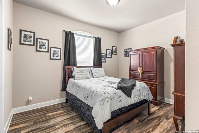 27418 Camellia Trce, Boerne, TX 78015 - bedroom with dark wood-style floors and baseboards