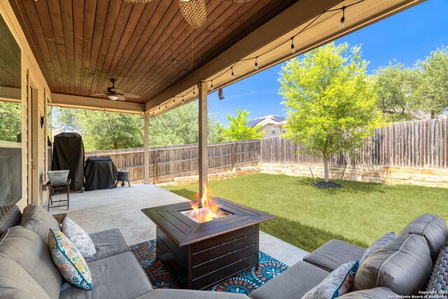 27418 Camellia Trce, Boerne, TX 78015 - fenced backyard with ceiling fan, an outdoor living space with a fire pit, and a patio area