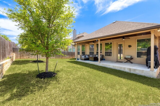 27418 Camellia Trce, Boerne, TX 78015 - fenced backyard featuring a ceiling fan, an outdoor hangout area, and a patio