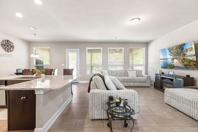 27418 Camellia Trce, Boerne, TX 78015 - living area with plenty of natural light, recessed lighting, a textured ceiling, and light tile patterned flooring