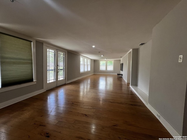 1024 W Mistletoe, San Antonio, TX 78201 - unfurnished living room featuring hardwood / wood-style flooring and baseboards