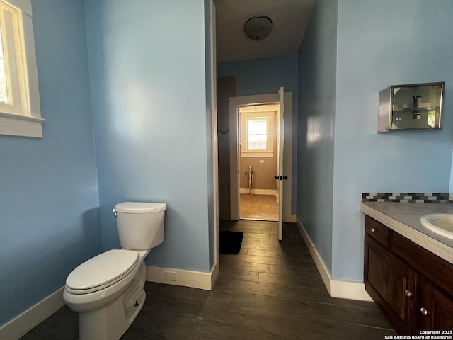 1024 W Mistletoe, San Antonio, TX 78201 - bathroom with toilet, wood finished floors, vanity, and baseboards