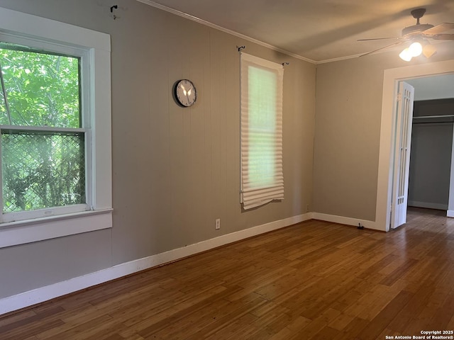 1024 W Mistletoe, San Antonio, TX 78201 - empty room with a ceiling fan, ornamental molding, wood finished floors, and plenty of natural light