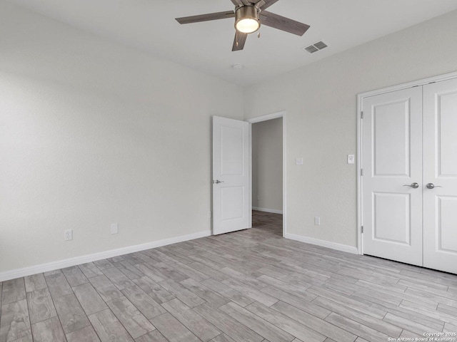 14329 Wisdom, Atascosa, TX 78002 - unfurnished bedroom featuring light wood finished floors, a closet, baseboards, and ceiling fan