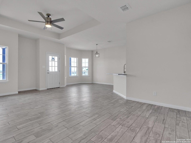14329 Wisdom, Atascosa, TX 78002 - unfurnished living room with light wood-type flooring, ceiling fan, and baseboards
