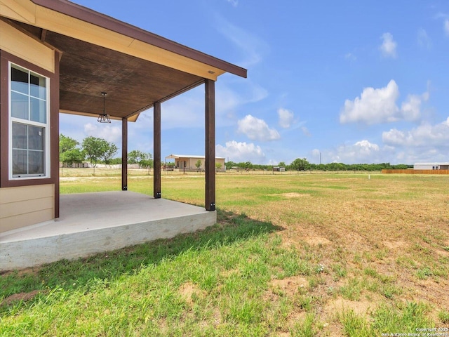 14329 Wisdom, Atascosa, TX 78002 - view of green lawn featuring a rural view and a patio