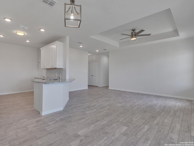 14329 Wisdom, Atascosa, TX 78002 - kitchen featuring a tray ceiling, a ceiling fan, baseboards, open floor plan, and recessed lighting