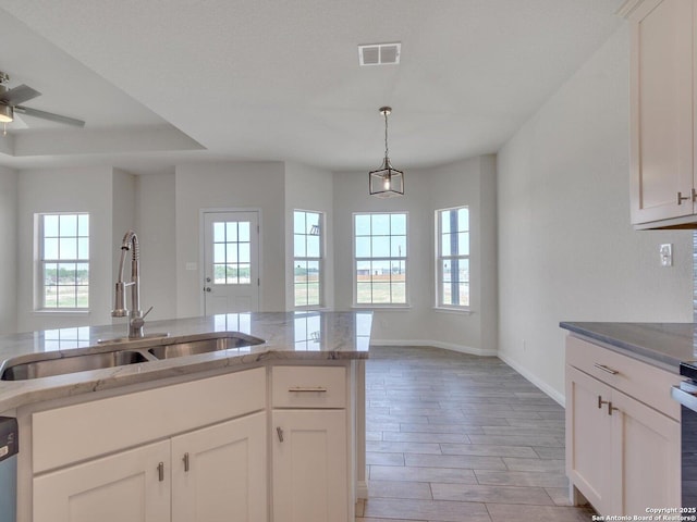 14329 Wisdom, Atascosa, TX 78002 - kitchen with a sink, healthy amount of natural light, light stone countertops, and baseboards