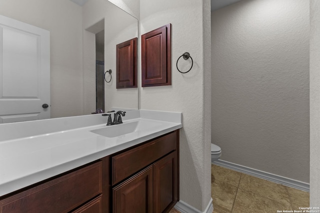 26011 Red Heron, San Antonio, TX 78261 - bathroom featuring vanity, toilet, a textured wall, and baseboards
