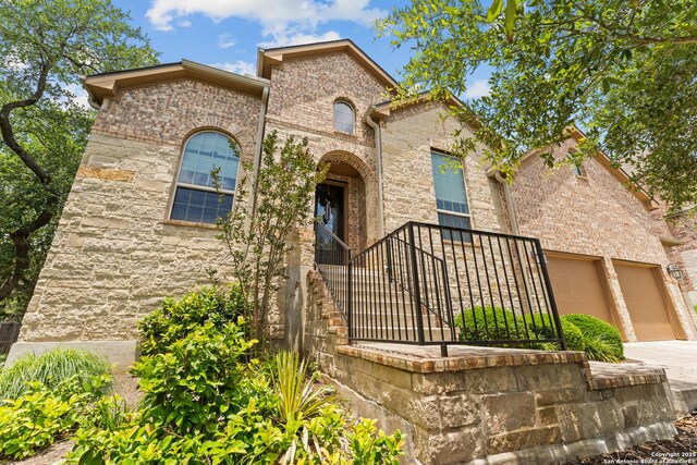 26011 Red Heron, San Antonio, TX 78261 - view of front of property with a garage, concrete driveway, brick siding, and stone siding