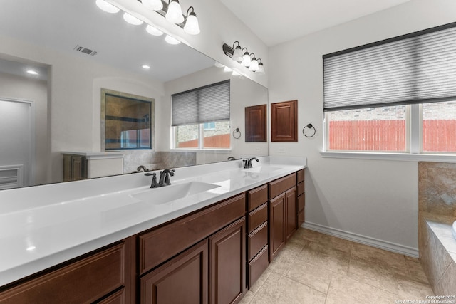 26011 Red Heron, San Antonio, TX 78261 - full bath featuring double vanity, tiled tub, baseboards, and tile patterned flooring