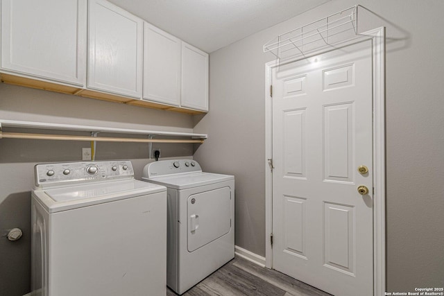 772 Copperfield, New Braunfels, TX 78130 - laundry room featuring cabinet space, washing machine and dryer, light wood-style floors, and baseboards