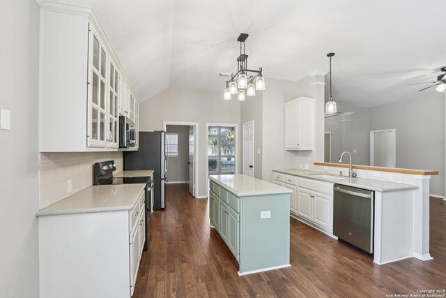 251 Las Brisas, Seguin, TX 78155 - kitchen featuring appliances with stainless steel finishes, a sink, a center island, decorative backsplash, and white cabinets