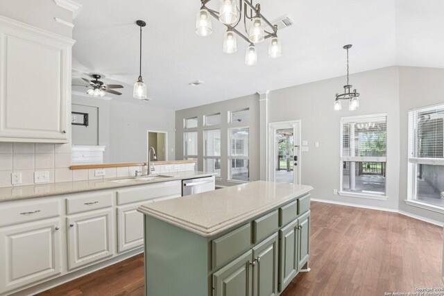 251 Las Brisas, Seguin, TX 78155 - kitchen featuring a chandelier, a sink, green cabinets, tasteful backsplash, and white cabinets