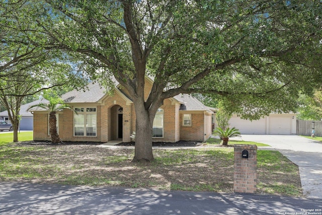 251 Las Brisas, Seguin, TX 78155 - view of front of home with concrete driveway, brick siding, and roof with shingles