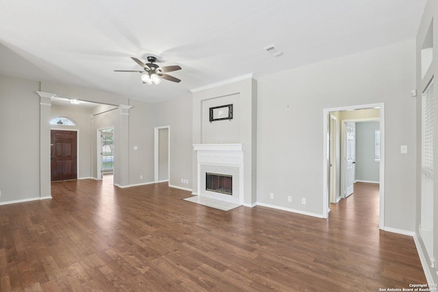 251 Las Brisas, Seguin, TX 78155 - unfurnished living room featuring a ceiling fan, dark wood-style flooring, a fireplace, and baseboards