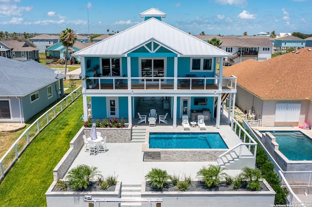 107 Windjammer, Rockport, TX 78382 - rear view of property with stairway, a hot tub, a residential view, and an outdoor pool