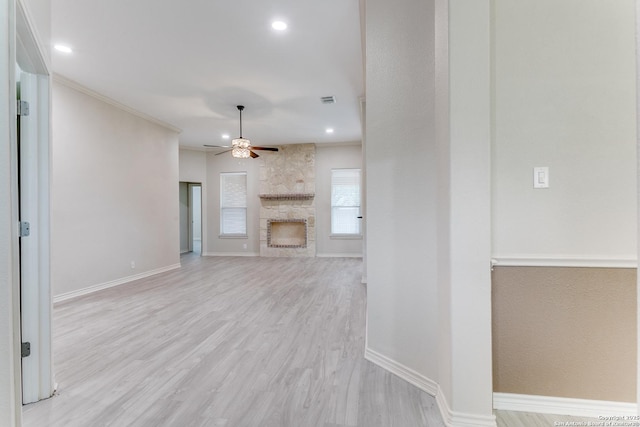 15608 York Ln, Selma, TX 78154 - unfurnished living room with ceiling fan, a stone fireplace, light wood finished floors, baseboards, and recessed lighting
