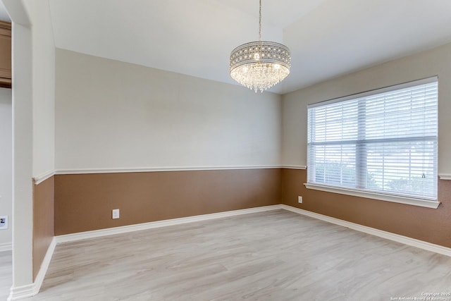 15608 York Ln, Selma, TX 78154 - empty room with light wood-style floors, a chandelier, and baseboards