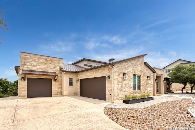 8602 Terra Mont Way, San Antonio, TX 78255 - contemporary house featuring an attached garage, a standing seam roof, stone siding, driveway, and metal roof