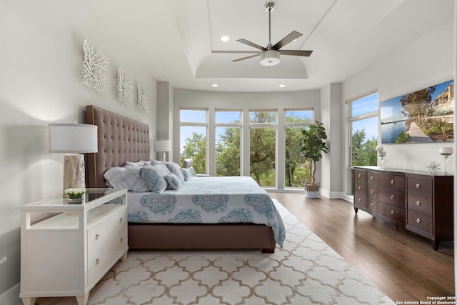 8602 Terra Mont Way, San Antonio, TX 78255 - bedroom featuring wood finished floors, recessed lighting, a ceiling fan, a raised ceiling, and baseboards
