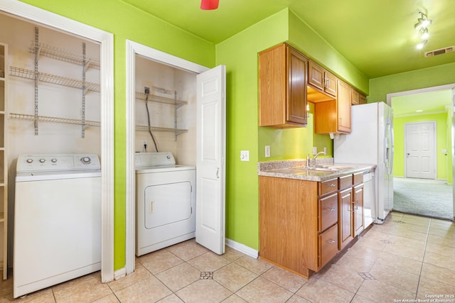 165 W Rampart Unit 204, San Antonio, TX 78216 - laundry area featuring washer / dryer, baseboards, and light tile patterned floors