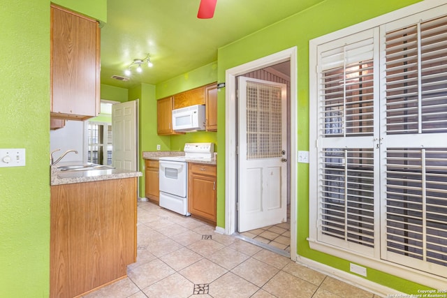 165 W Rampart Unit 204, San Antonio, TX 78216 - kitchen with white appliances, a sink, light countertops, light tile patterned floors, and a ceiling fan