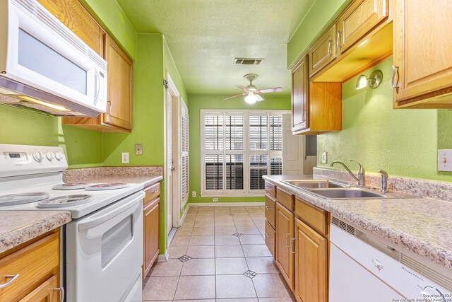 165 W Rampart Unit 204, San Antonio, TX 78216 - kitchen featuring white appliances, a sink, a ceiling fan, light countertops, and light tile patterned floors