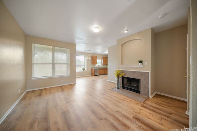 9026 Foxgrove Way, San Antonio, TX 78251 - unfurnished living room featuring light wood-style flooring, baseboards, and a fireplace