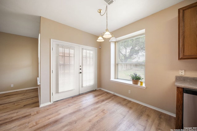 9026 Foxgrove Way, San Antonio, TX 78251 - unfurnished dining area with light wood finished floors, french doors, and baseboards