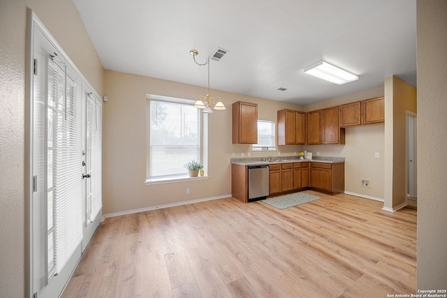 9026 Foxgrove Way, San Antonio, TX 78251 - kitchen featuring dishwasher, light wood-type flooring, brown cabinetry, light countertops, and pendant lighting