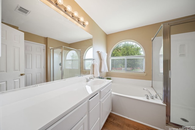 9026 Foxgrove Way, San Antonio, TX 78251 - full bathroom featuring a shower stall, vanity, a bath, and wood finished floors