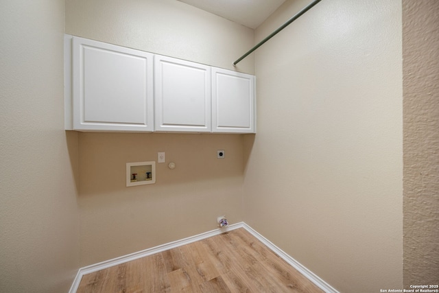 9026 Foxgrove Way, San Antonio, TX 78251 - washroom with hookup for a gas dryer, hookup for an electric dryer, washer hookup, light wood-style flooring, and cabinet space