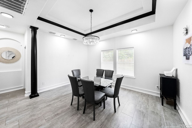 3307 W Salinas, San Antonio, TX 78207 - dining room with ornate columns, a chandelier, a raised ceiling, and baseboards