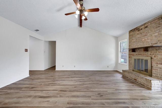 5810 Sky Country, San Antonio, TX 78247 - unfurnished living room with a ceiling fan, wood finished floors, a textured ceiling, and a fireplace