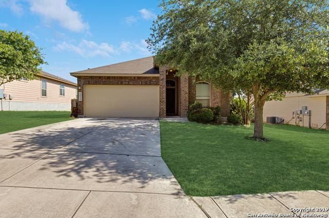 11515 Wayward Daisy, San Antonio, TX 78245 - view of front of home with an attached garage, concrete driveway, a front yard, and brick siding