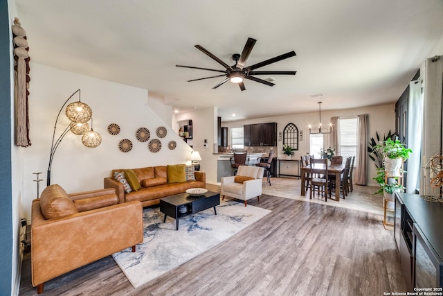 3006 Mission Bell, San Antonio, TX 78224 - living room featuring ceiling fan, light wood finished floors, and a chandelier