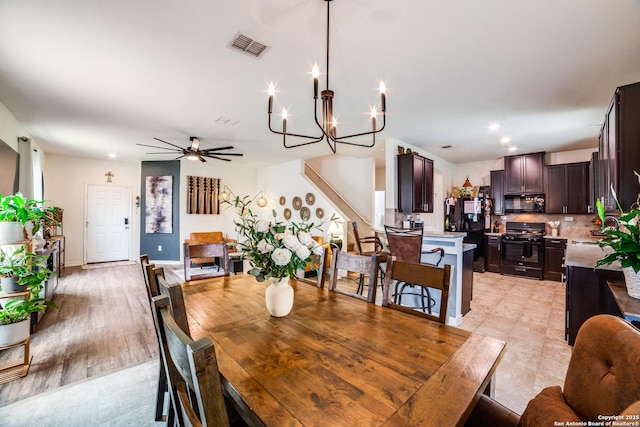 3006 Mission Bell, San Antonio, TX 78224 - dining room with a chandelier, ceiling fan, and stairway