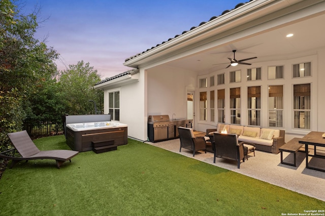 24706 Moorland, San Antonio, TX 78257 - yard at dusk with a hot tub, a lawn, a patio area, an outdoor living space with a fire pit, and a ceiling fan