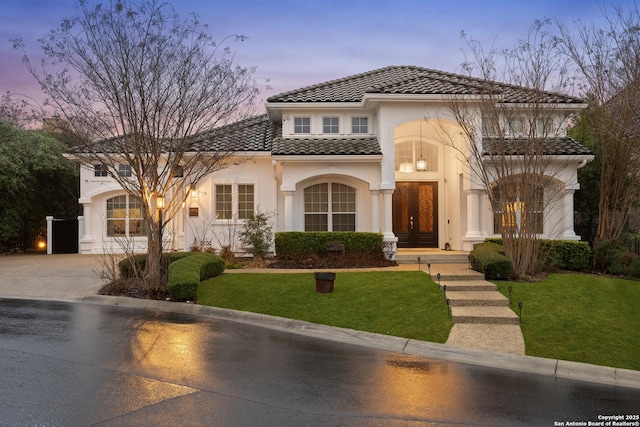 24706 Moorland, San Antonio, TX 78257 - mediterranean / spanish house featuring french doors, a tiled roof, stucco siding, driveway, and a front lawn