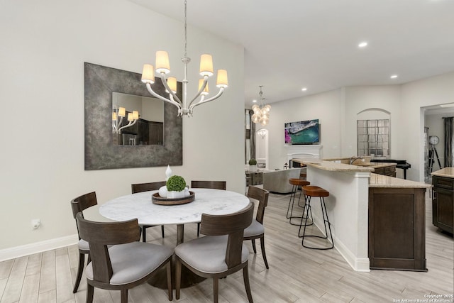 24706 Moorland, San Antonio, TX 78257 - dining room featuring a chandelier, light wood-style flooring, baseboards, and recessed lighting