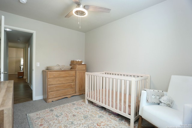6203 Callen Gln, San Antonio, TX 78233 - carpeted bedroom with baseboards, a crib, and ceiling fan