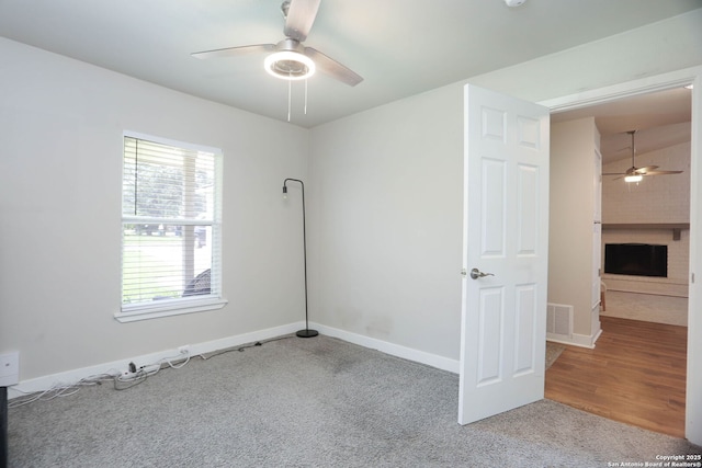 6203 Callen Gln, San Antonio, TX 78233 - carpeted spare room featuring a ceiling fan, a large fireplace, and baseboards