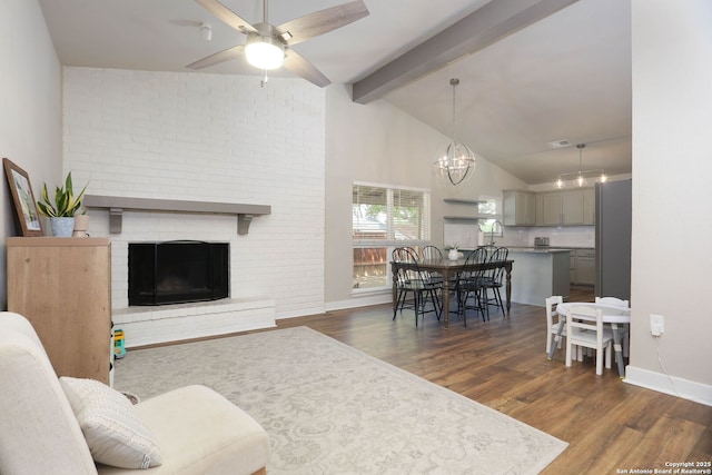 6203 Callen Gln, San Antonio, TX 78233 - living room with dark wood-type flooring, baseboards, a ceiling fan, a brick fireplace, and a chandelier